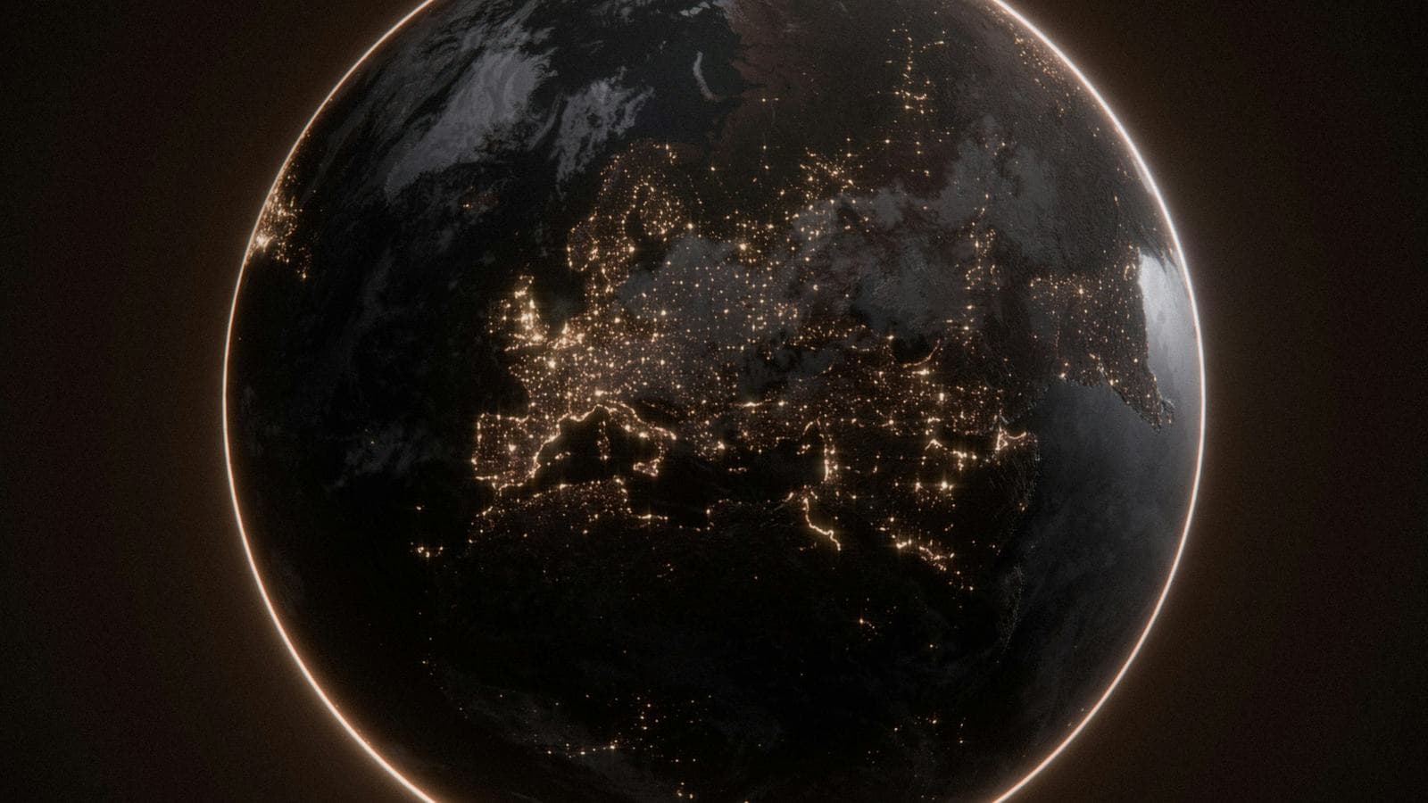 The Earth seen from space at night, with the city lights of Europe glowing against the dark planet and a thin bright ring of atmosphere around its edge. Cloud providers run data centre regions across the globe so users can be served from somewhere nearby