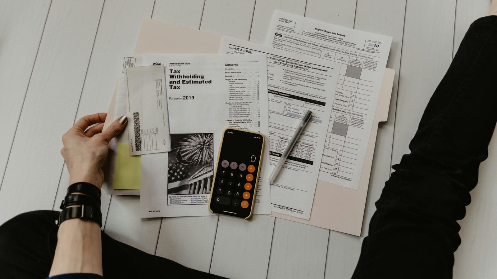 A desk with a calculator and printed estimates — the quote is the smallest number in this decision