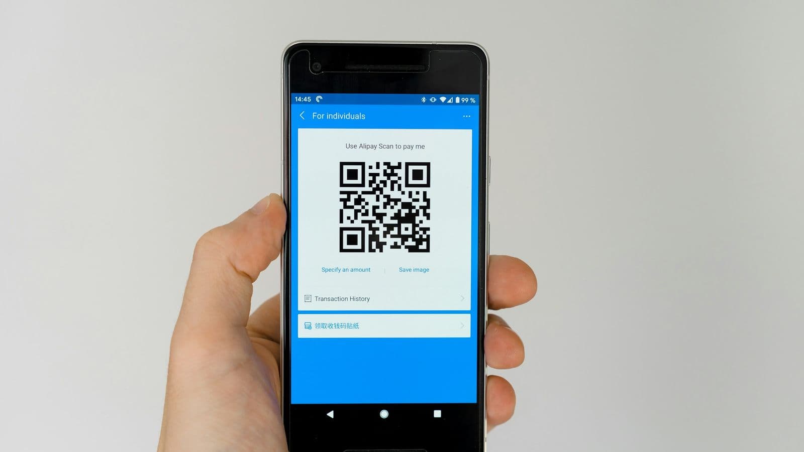 Scanning a QR code to pay — in India a fintech product that treats UPI as secondary is building against the market
