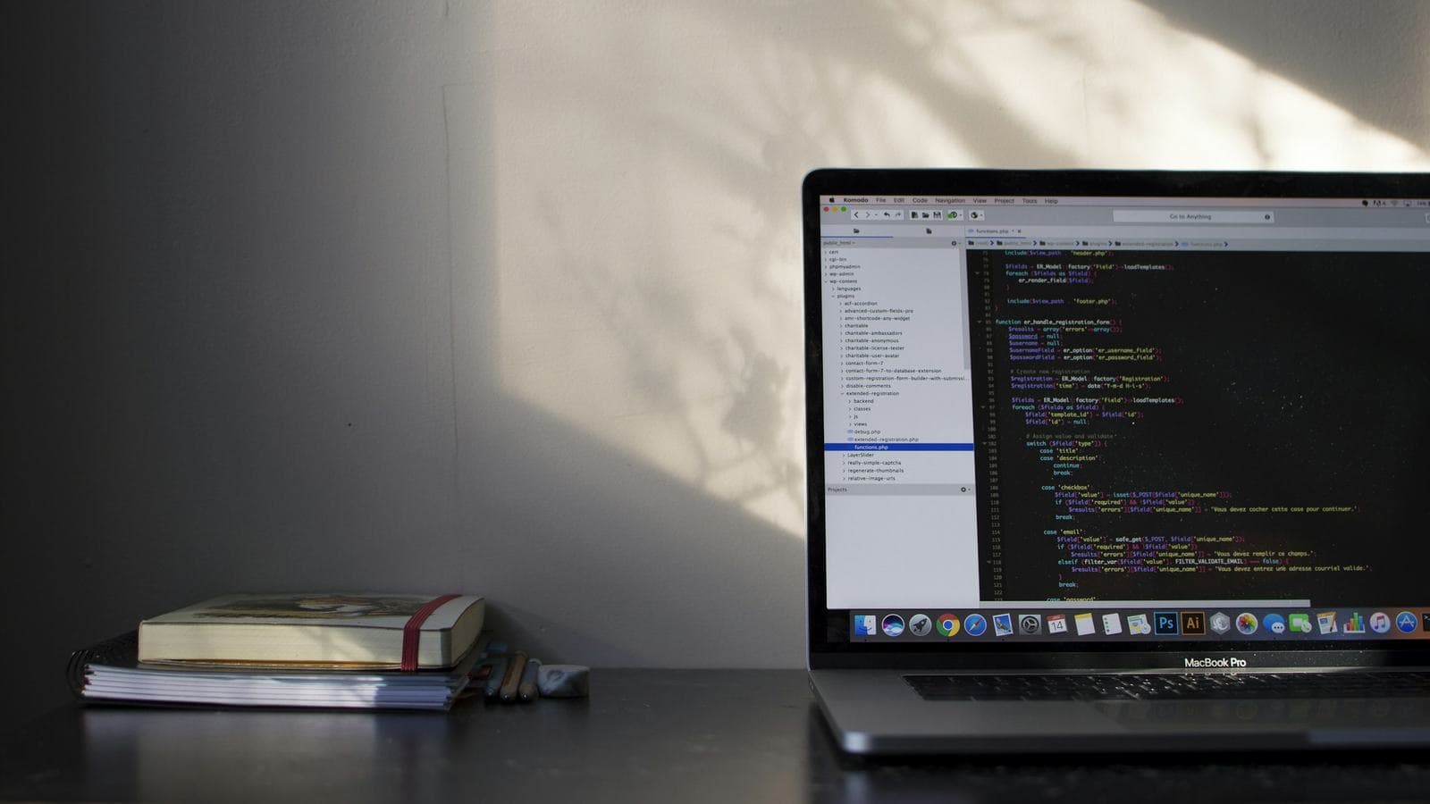 A laptop open on a dark desk late in the evening, with code on the screen and a couple of books beside it. The preparation that lands an internship usually happens months before the application goes in
