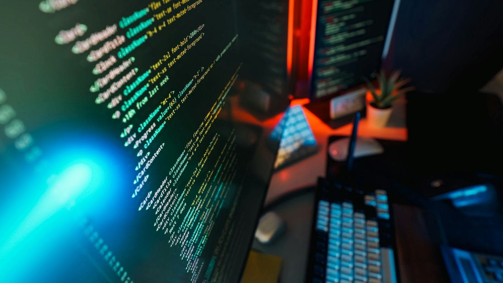 Colourful code on a dark monitor. Most of WhatsApp's scaling came from careful engineering decisions, not from a huge headcount