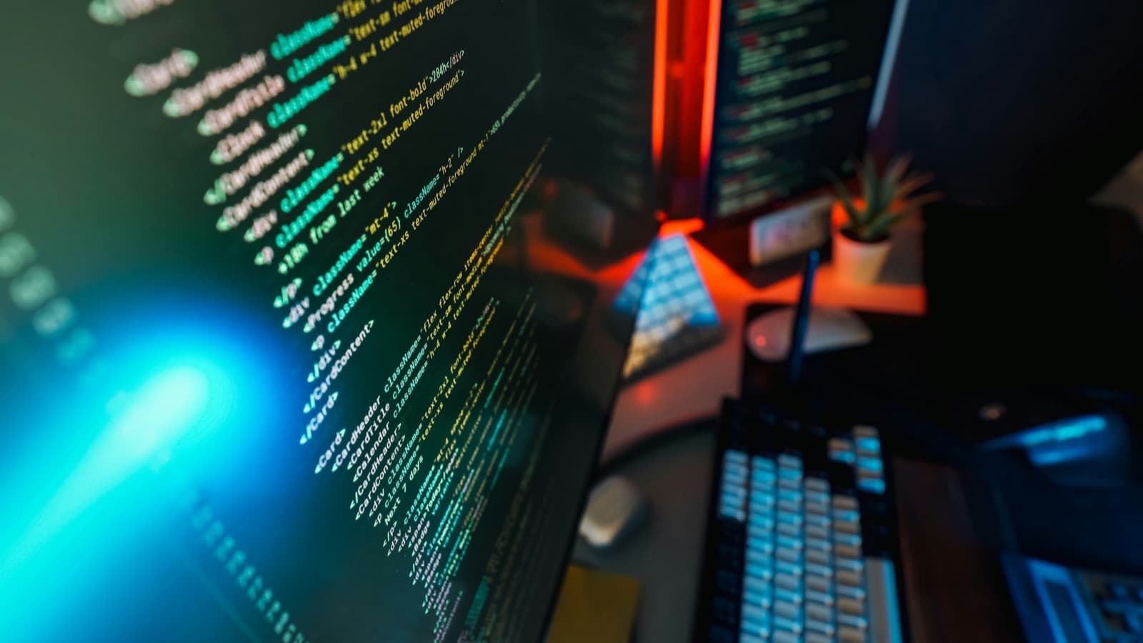 React component code glowing on a monitor in a dark room — the architecture of a Next.js app is decided in a handful of files long before it's visible on the screen