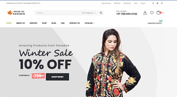 Pride of Kashmir storefront homepage, with a product search bar, account, wishlist and cart icons, and a Winter Sale 10% off banner showing a model in a black pheran with colourful floral embroidery